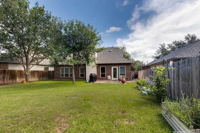 rear view of property with a patio area and a lawn