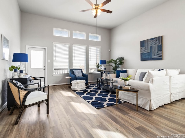 living room with ceiling fan and hardwood / wood-style floors