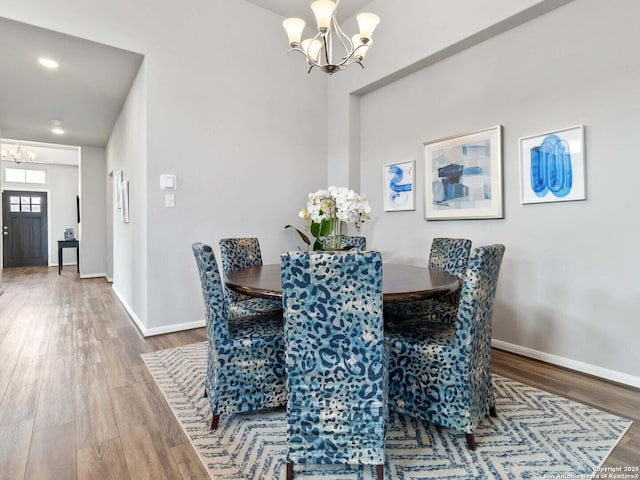 dining space featuring a chandelier and wood-type flooring