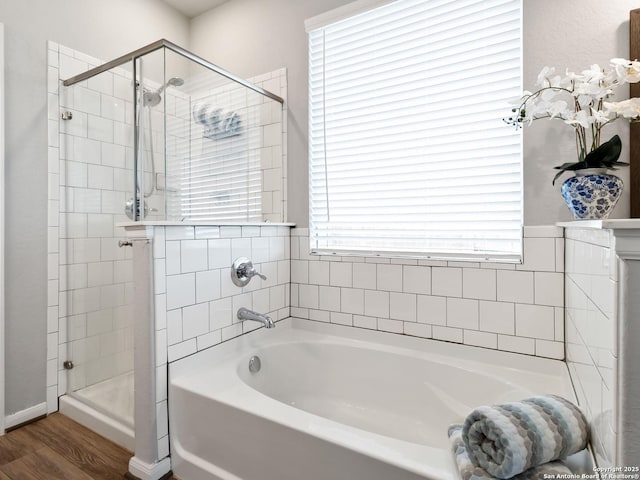 bathroom with hardwood / wood-style flooring and plus walk in shower