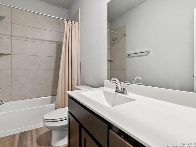 full bathroom featuring toilet, hardwood / wood-style flooring, shower / tub combo with curtain, and vanity