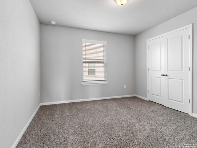 unfurnished bedroom featuring carpet floors and a closet