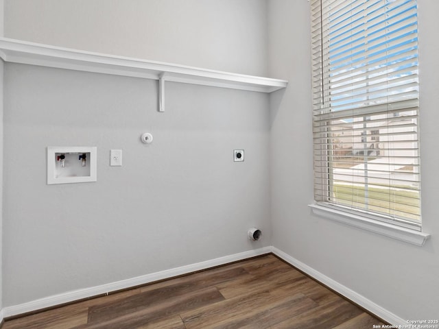 washroom with dark wood-type flooring, hookup for an electric dryer, hookup for a washing machine, and hookup for a gas dryer