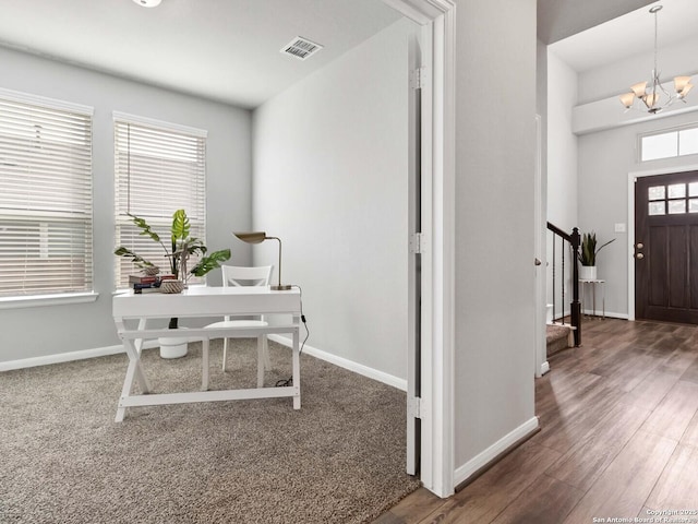 office featuring a notable chandelier, dark hardwood / wood-style floors, and plenty of natural light