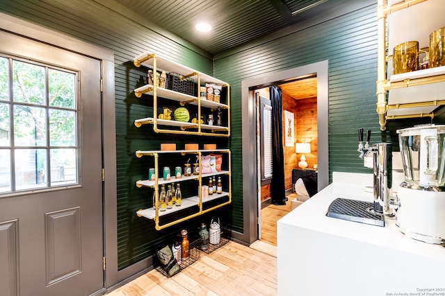 interior space featuring wood walls and light hardwood / wood-style flooring