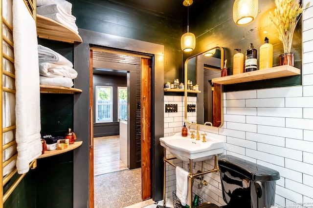 bathroom featuring wood walls