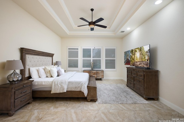 bedroom featuring a raised ceiling, ceiling fan, and crown molding