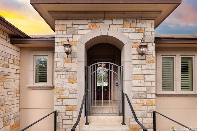 view of exterior entry at dusk