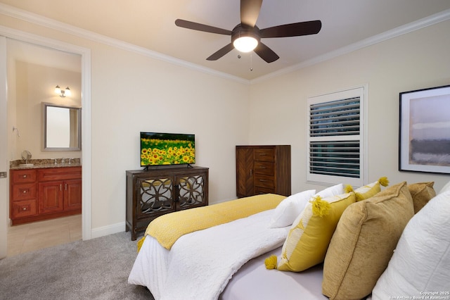 bedroom featuring sink, ceiling fan, ensuite bath, crown molding, and light colored carpet