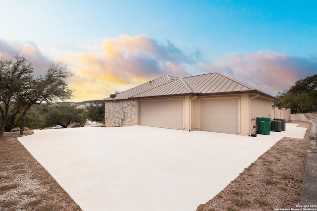 property exterior at dusk featuring central air condition unit