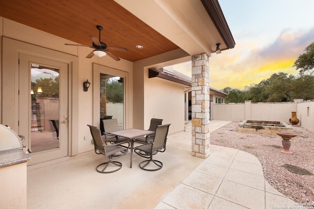 patio terrace at dusk with ceiling fan