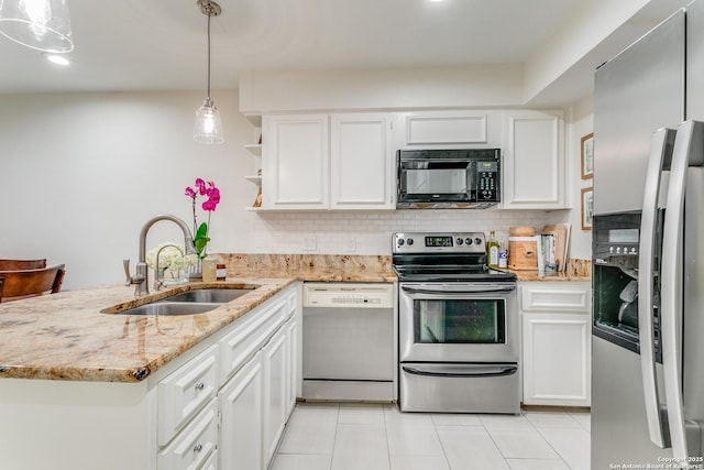 kitchen featuring appliances with stainless steel finishes, kitchen peninsula, pendant lighting, sink, and white cabinetry