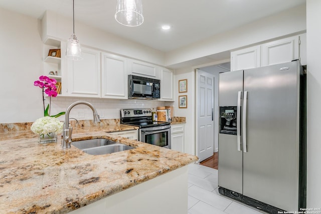 kitchen featuring decorative light fixtures, white cabinets, appliances with stainless steel finishes, and sink