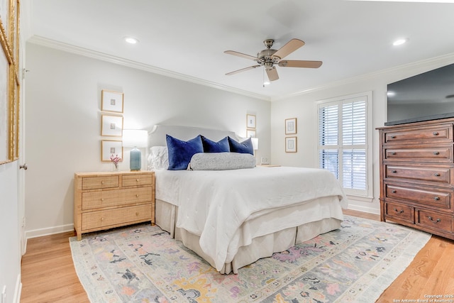 bedroom featuring ceiling fan, ornamental molding, and wood-type flooring