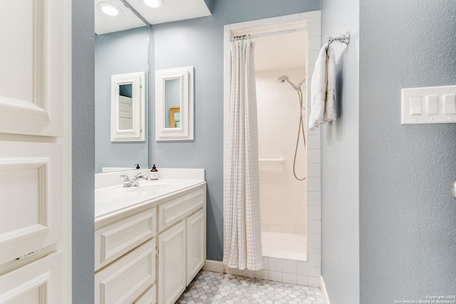 bathroom with curtained shower, vanity, and tile patterned flooring