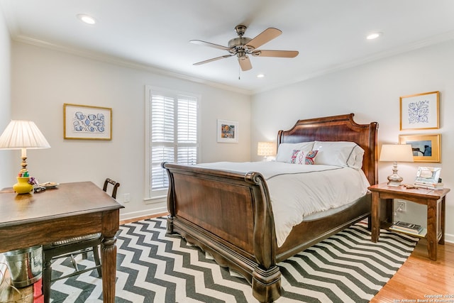 bedroom with ornamental molding, ceiling fan, and light wood-type flooring