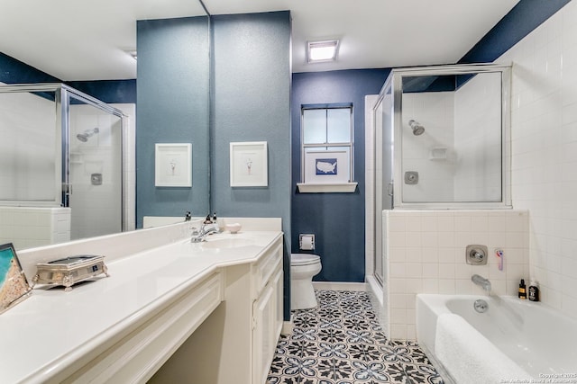 full bathroom featuring toilet, vanity, tile patterned flooring, and independent shower and bath