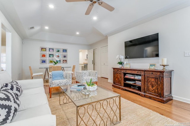 living room with ceiling fan, crown molding, and light hardwood / wood-style floors