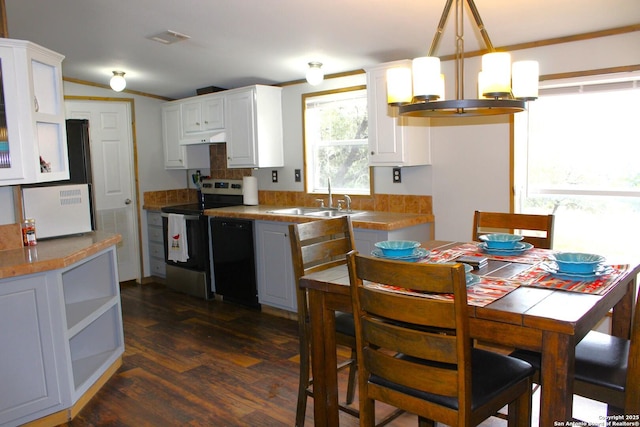 kitchen featuring pendant lighting, dark hardwood / wood-style floors, stainless steel range with electric cooktop, white cabinets, and sink