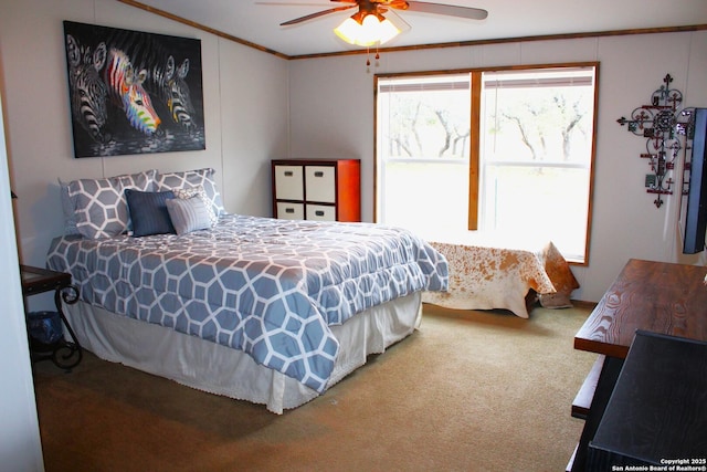 bedroom featuring ceiling fan, multiple windows, ornamental molding, and carpet floors