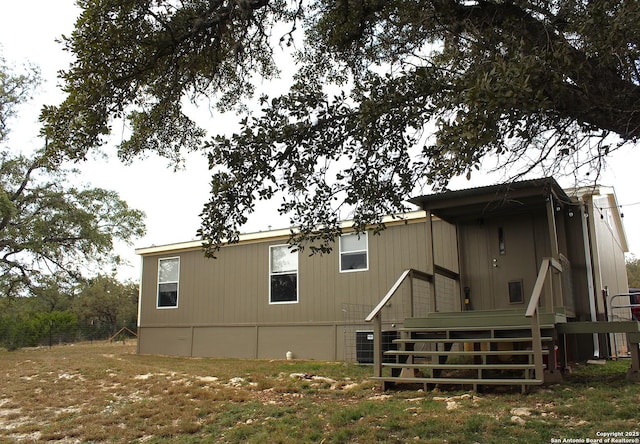 back of house with central AC unit