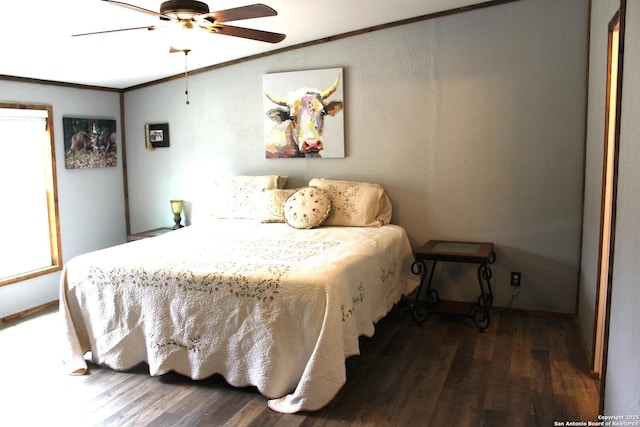 bedroom with dark wood-type flooring, ceiling fan, and ornamental molding