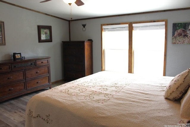 bedroom featuring ceiling fan, vaulted ceiling, crown molding, and wood-type flooring