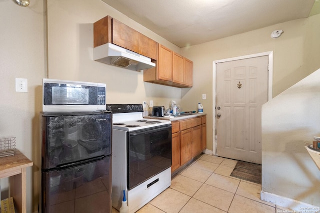 kitchen featuring sink, white electric range oven, and light tile patterned floors