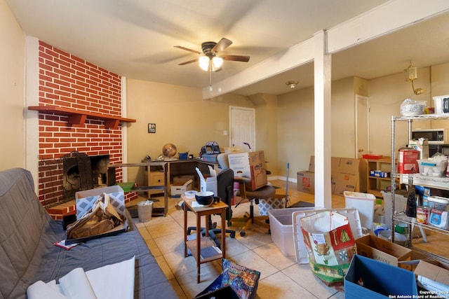 tiled living room with a fireplace and ceiling fan