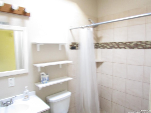 bathroom with toilet, vanity, and a shower with curtain