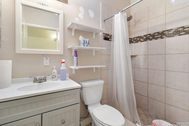 bathroom featuring toilet, vanity, and curtained shower