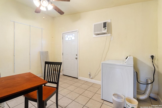 clothes washing area featuring washer / clothes dryer, a wall unit AC, ceiling fan, and light tile patterned floors