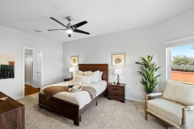 bedroom with ensuite bath, ceiling fan, and carpet