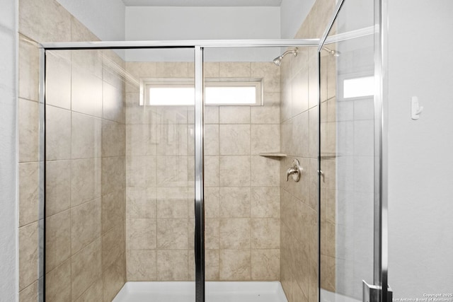 bathroom featuring a shower with door