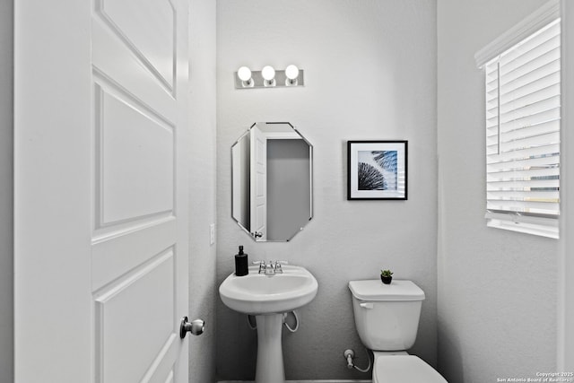 bathroom with toilet and plenty of natural light