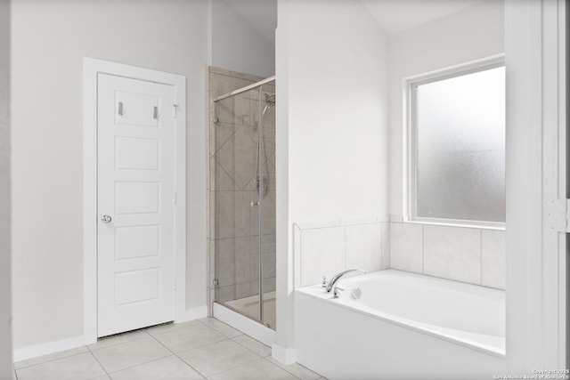 bathroom with tile patterned flooring, a shower stall, baseboards, and a bath