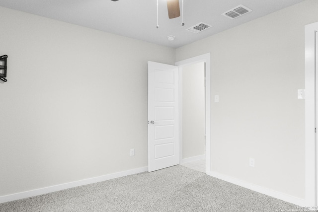 empty room featuring baseboards, carpet, visible vents, and a ceiling fan