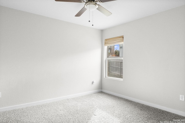 carpeted spare room featuring ceiling fan and baseboards