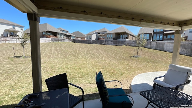 view of patio / terrace with a fenced backyard and a residential view