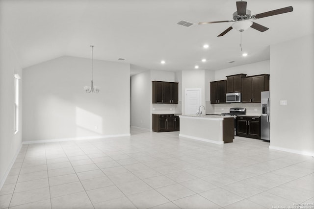 kitchen featuring a center island with sink, appliances with stainless steel finishes, light tile patterned floors, decorative backsplash, and ceiling fan with notable chandelier