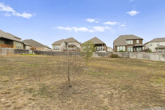 view of yard featuring fence and a residential view