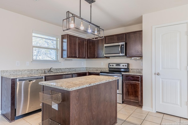 kitchen featuring stainless steel appliances, dark brown cabinets, a center island, and hanging light fixtures