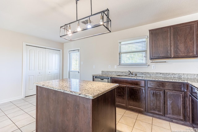 kitchen with sink, a center island, dishwasher, light tile patterned floors, and hanging light fixtures