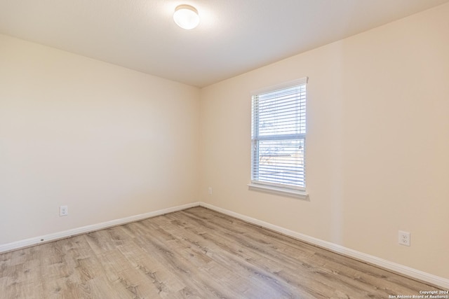 unfurnished room with light hardwood / wood-style floors