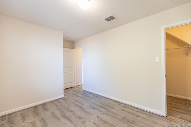 unfurnished room with light hardwood / wood-style floors