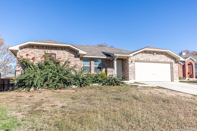 ranch-style house featuring a front yard and a garage