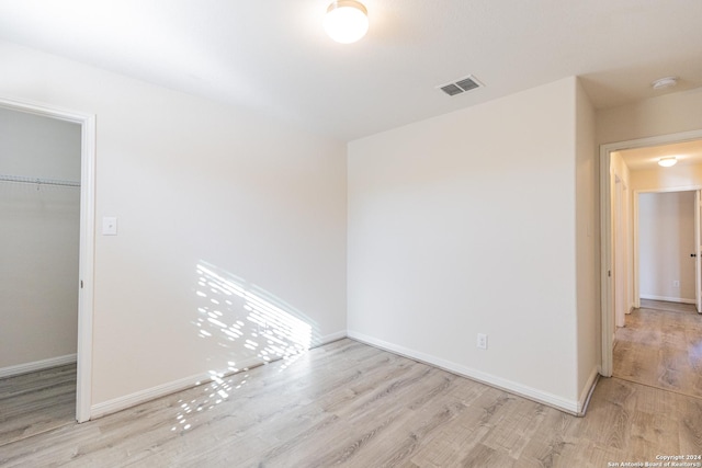 spare room featuring light wood-type flooring