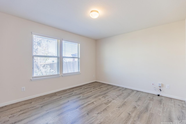 unfurnished room with light hardwood / wood-style floors