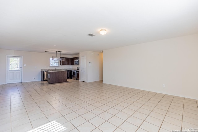 unfurnished living room featuring light tile patterned floors