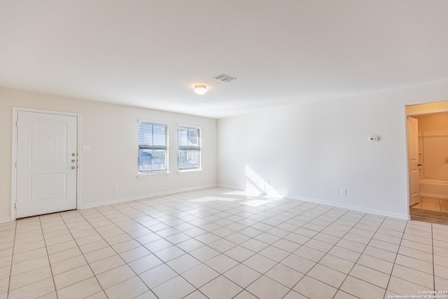 unfurnished room featuring light tile patterned flooring